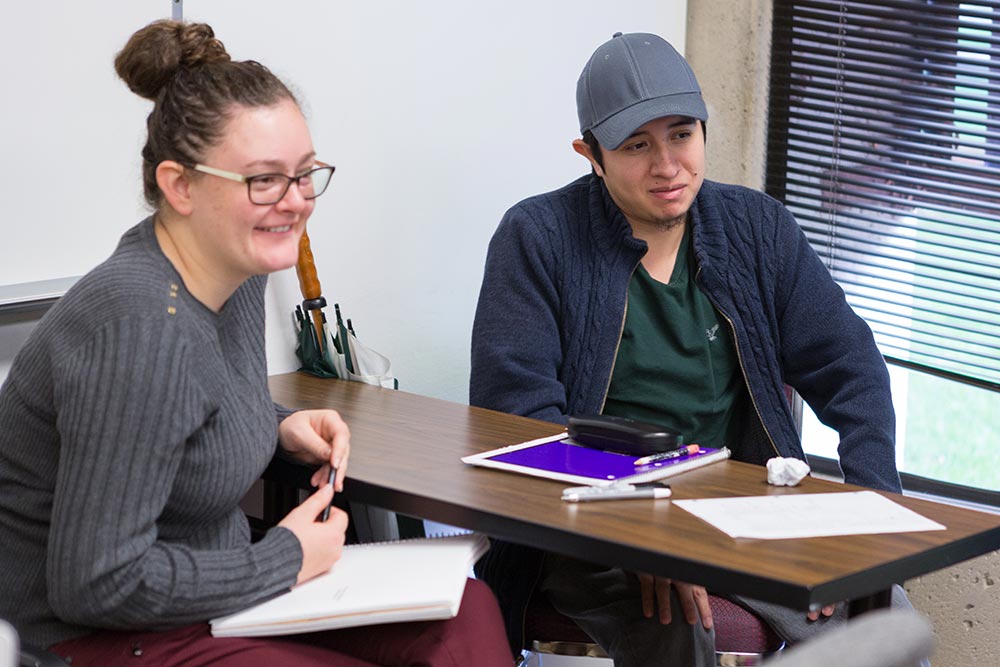 WOU-students-in-class Student and advisor at a desk