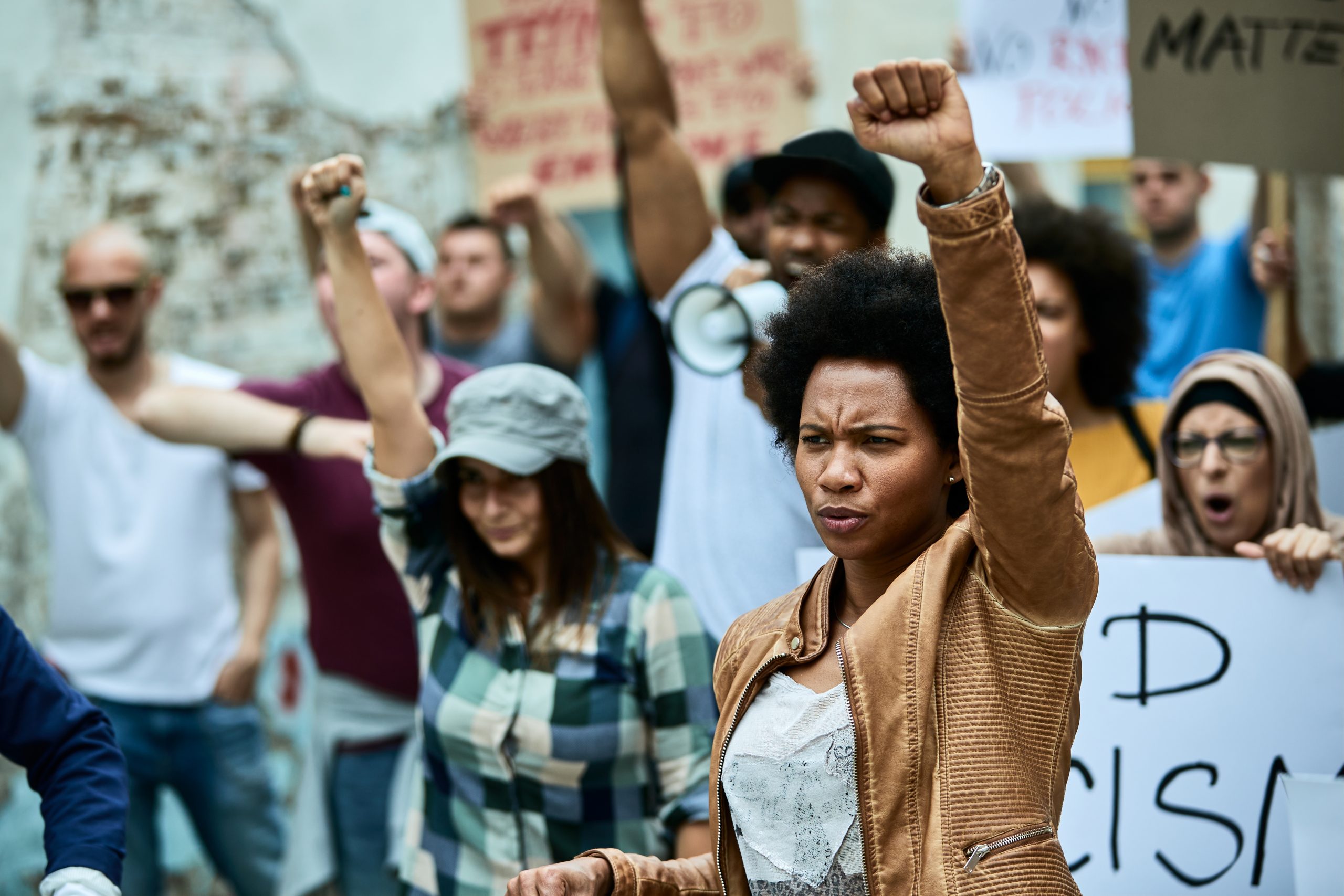 African,American,Woman,With,Raised,Fist,Participating,In,Black,Civil People with arms up in the air holding signs