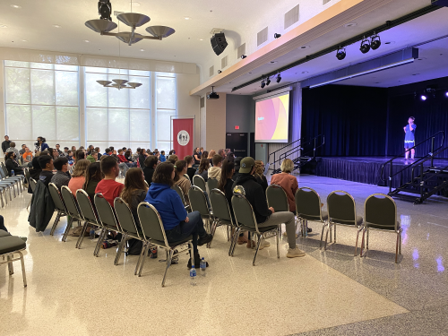 attendees watch the stage at an ASL Club event