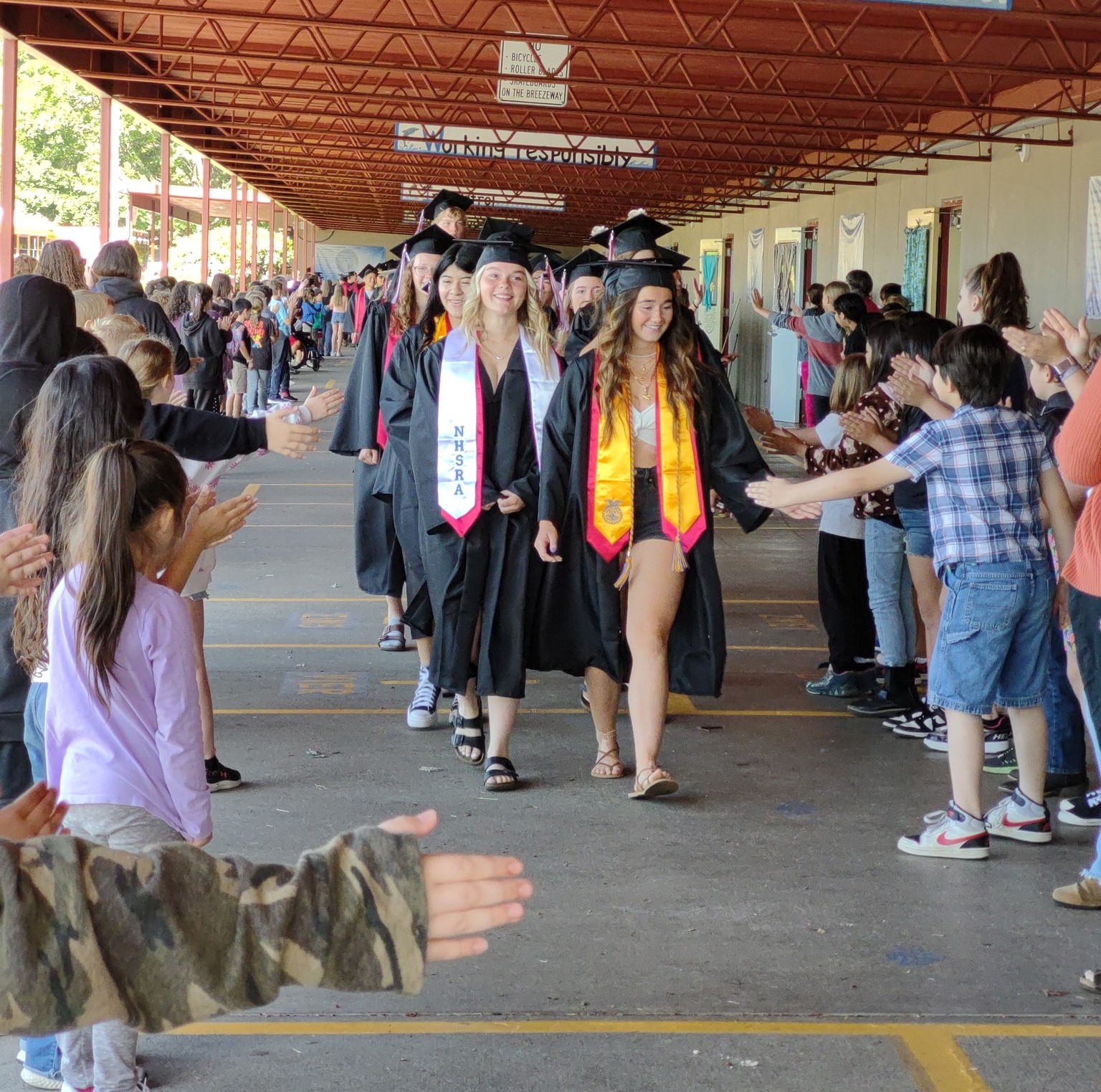 CHS Graduation 2024 walk halls of MES Student in basket chair with a laptop on their lap