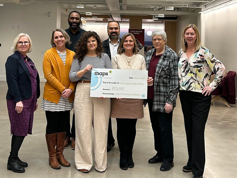 WOU staff holding MAPS donation check