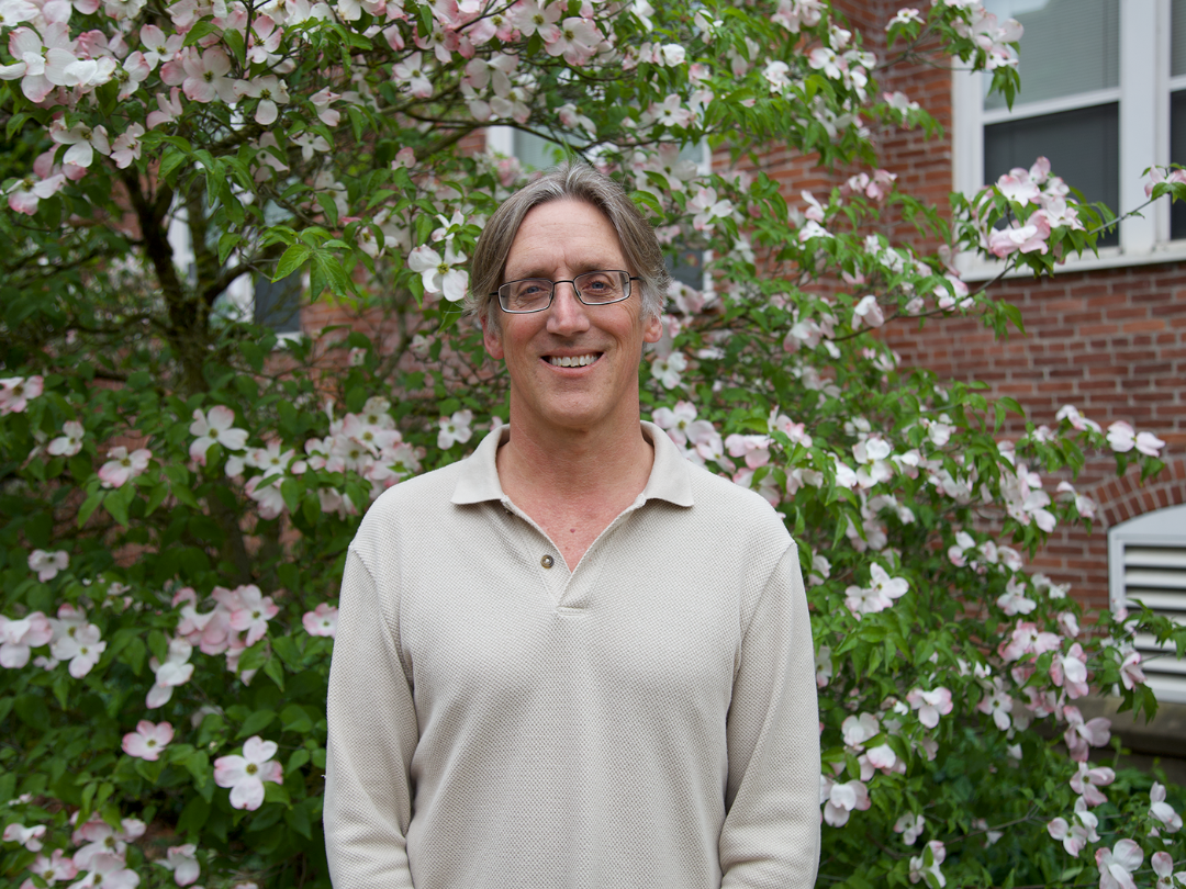 Gentle PR Image of man in front of greenery
