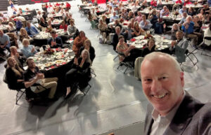 Image of man taking a selfie with group