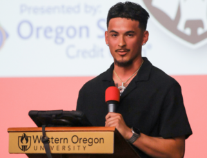 A man standing at a podium with a microphone