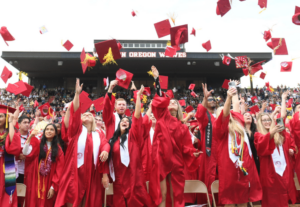 A crowd of college graduates celebrating