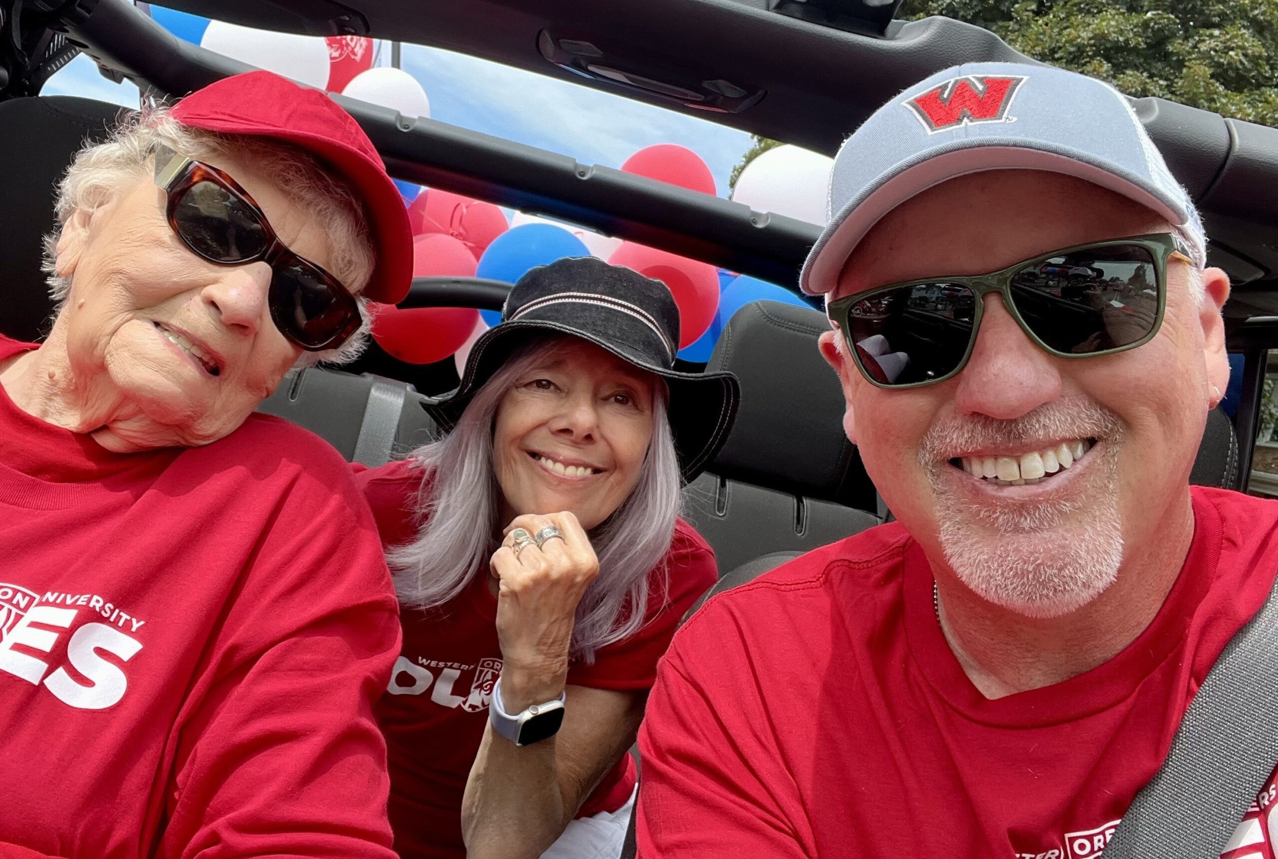 Three people smiling in a car