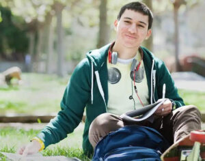 A student sitting on grass