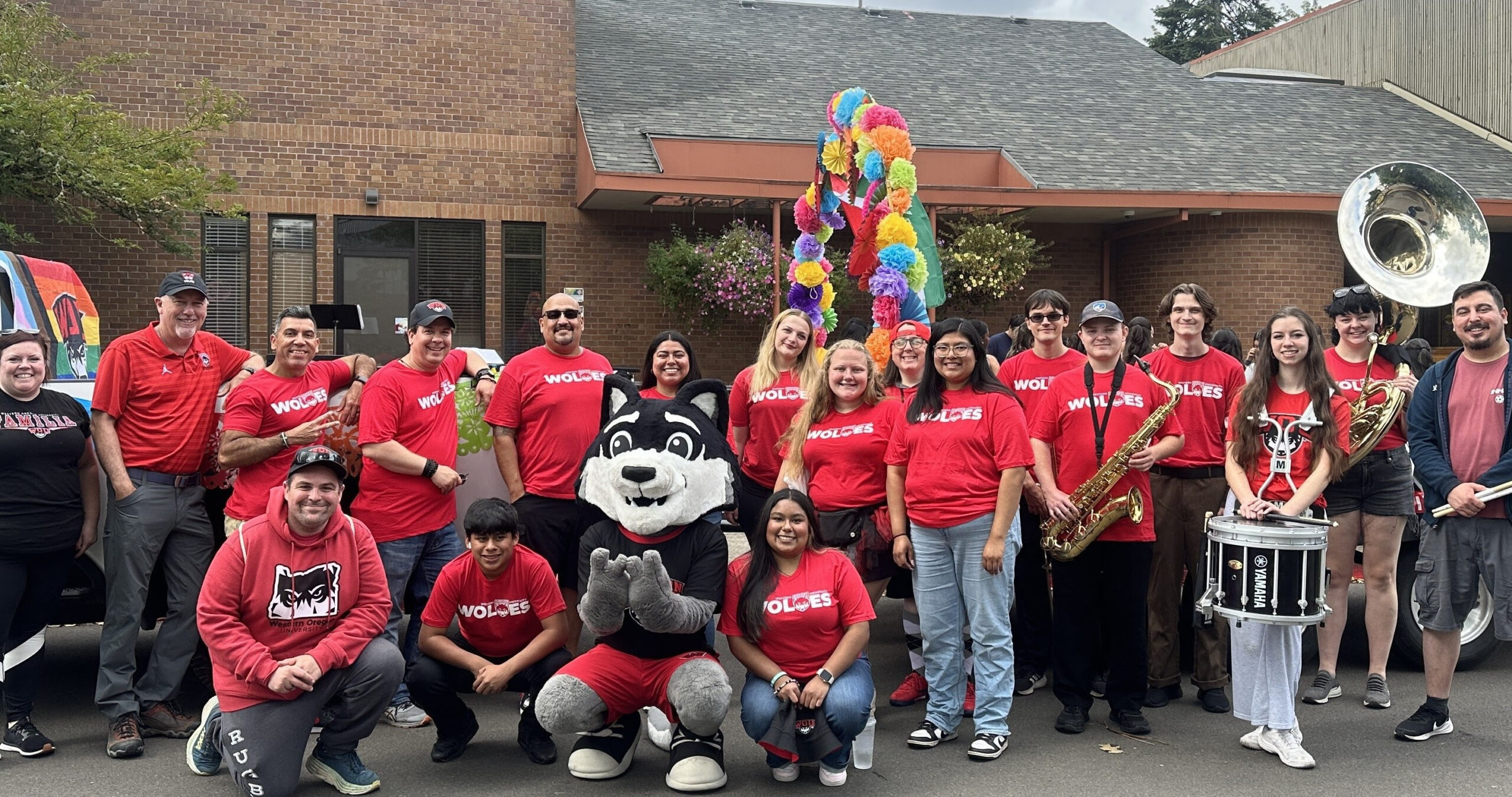 redshirtssmiling People wearing red shirts smiling with a wolf mascot