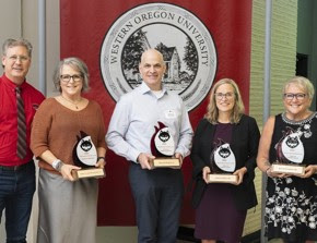 Group of people holding trophies