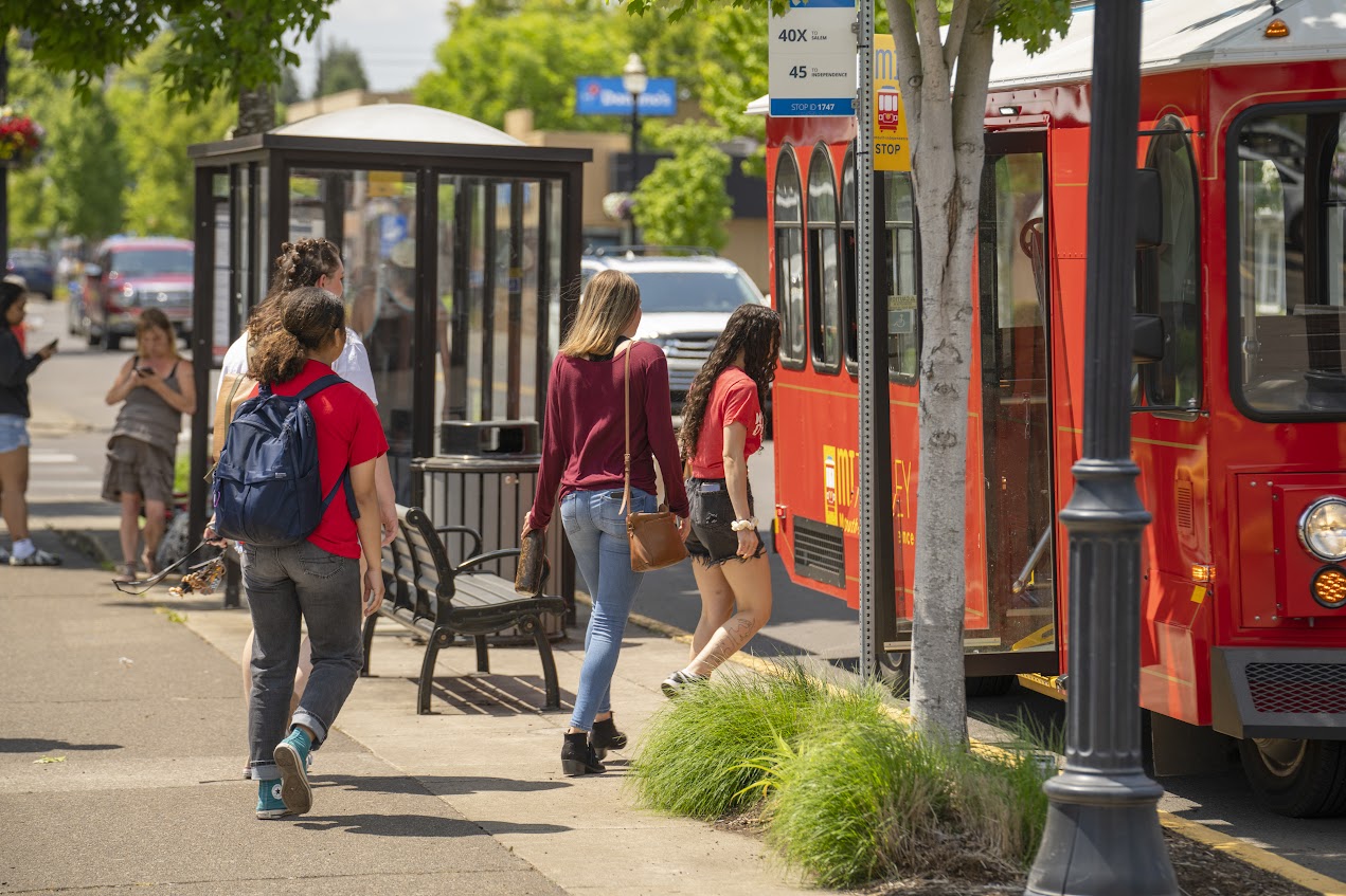 Students walking towards the Monmouth Trolley Bus