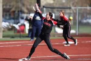 WOU softball player throwing the ball