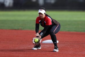 WOU softball player fielding a ball