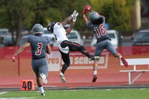 WOU football player intercepting the ball