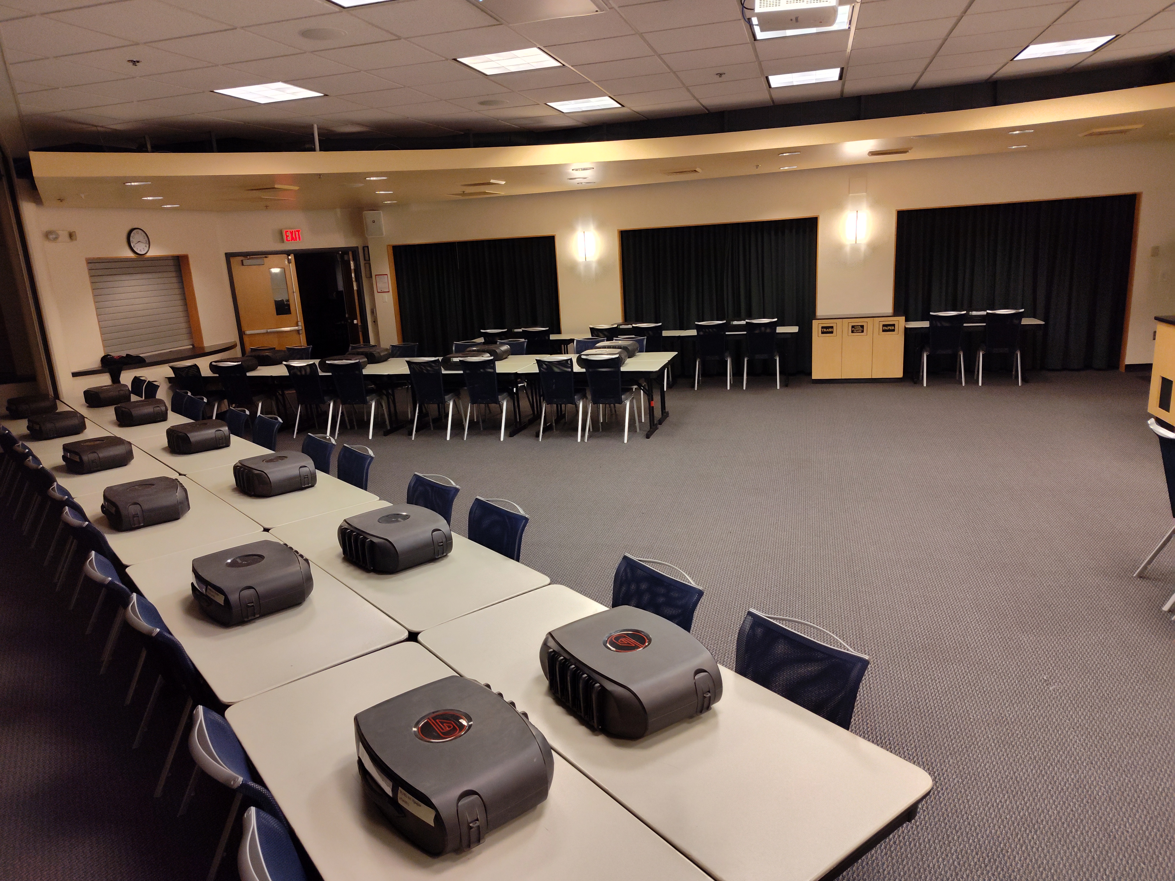 Several consoles set up in a conference room.