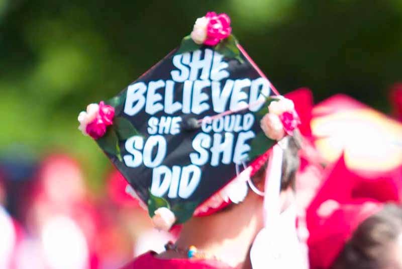 first-gen-spot Graduate with grad cap that says She believed she could so she did