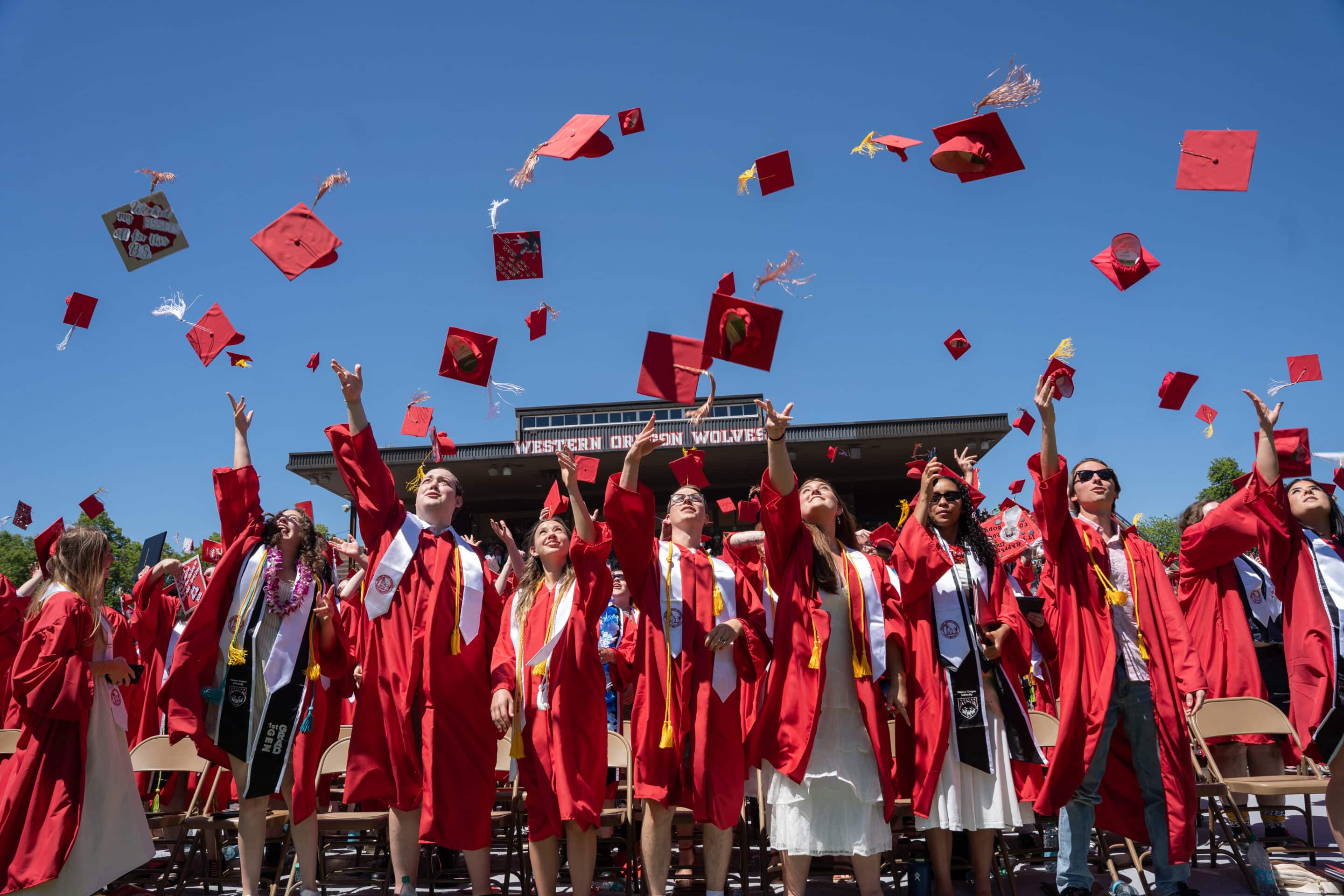 Graduates throwing caps and gowns into the air
