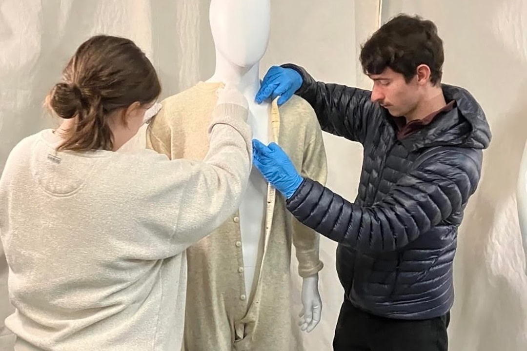 WOU History Club members arrange textiles for documentation.