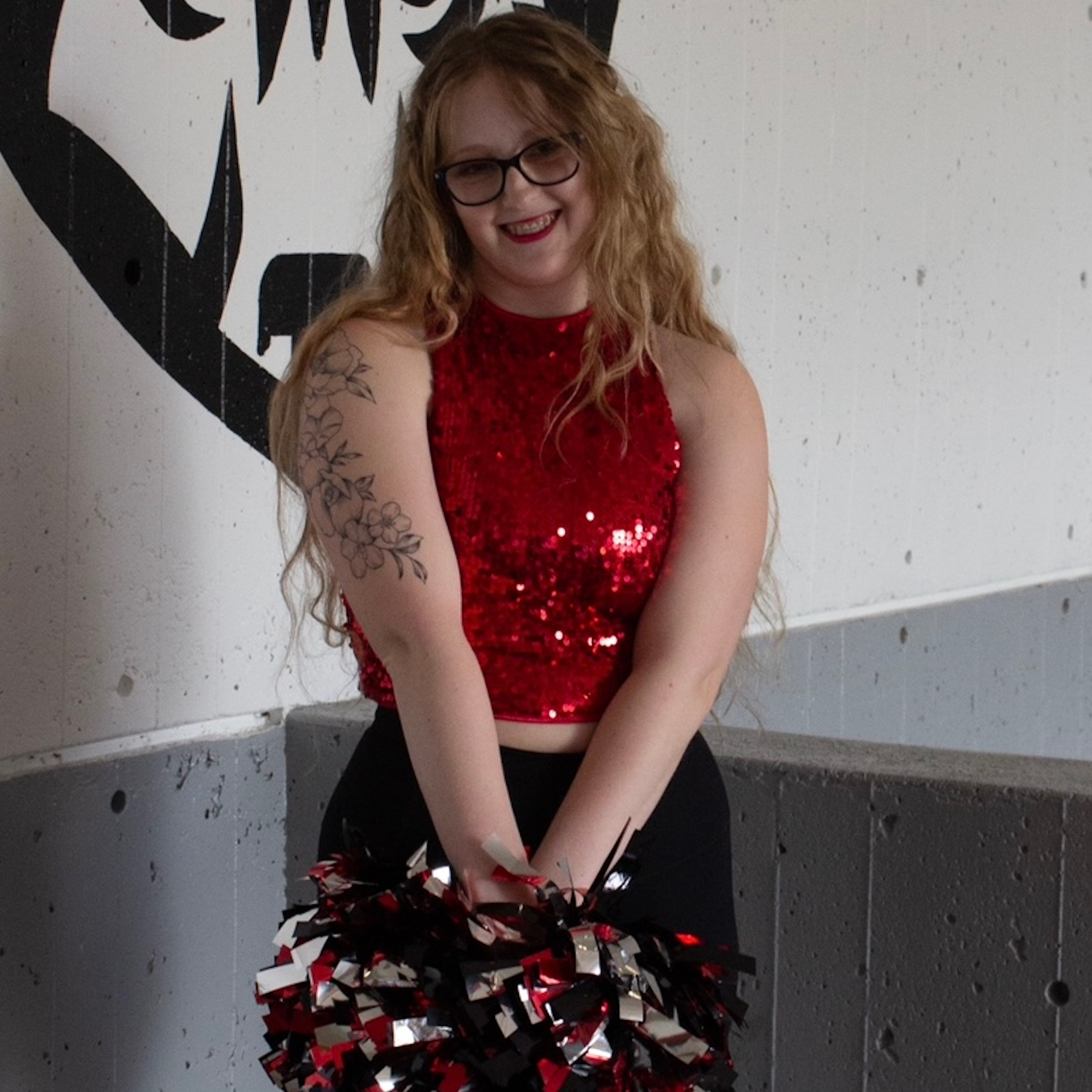 Smiling young person in a cheerleader outfit.