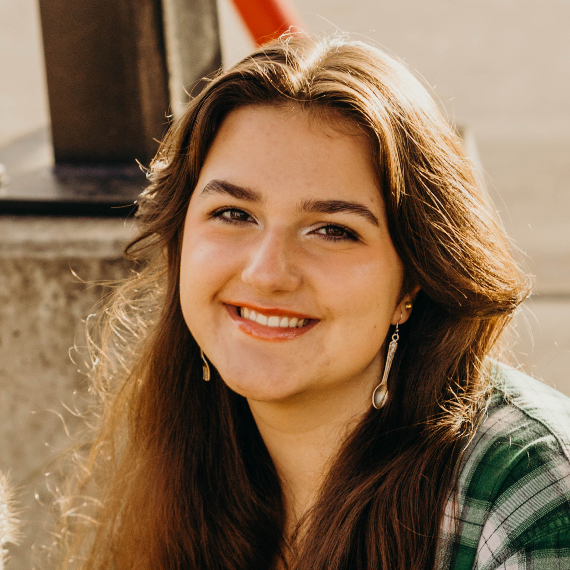Smiling young person with brown hair.