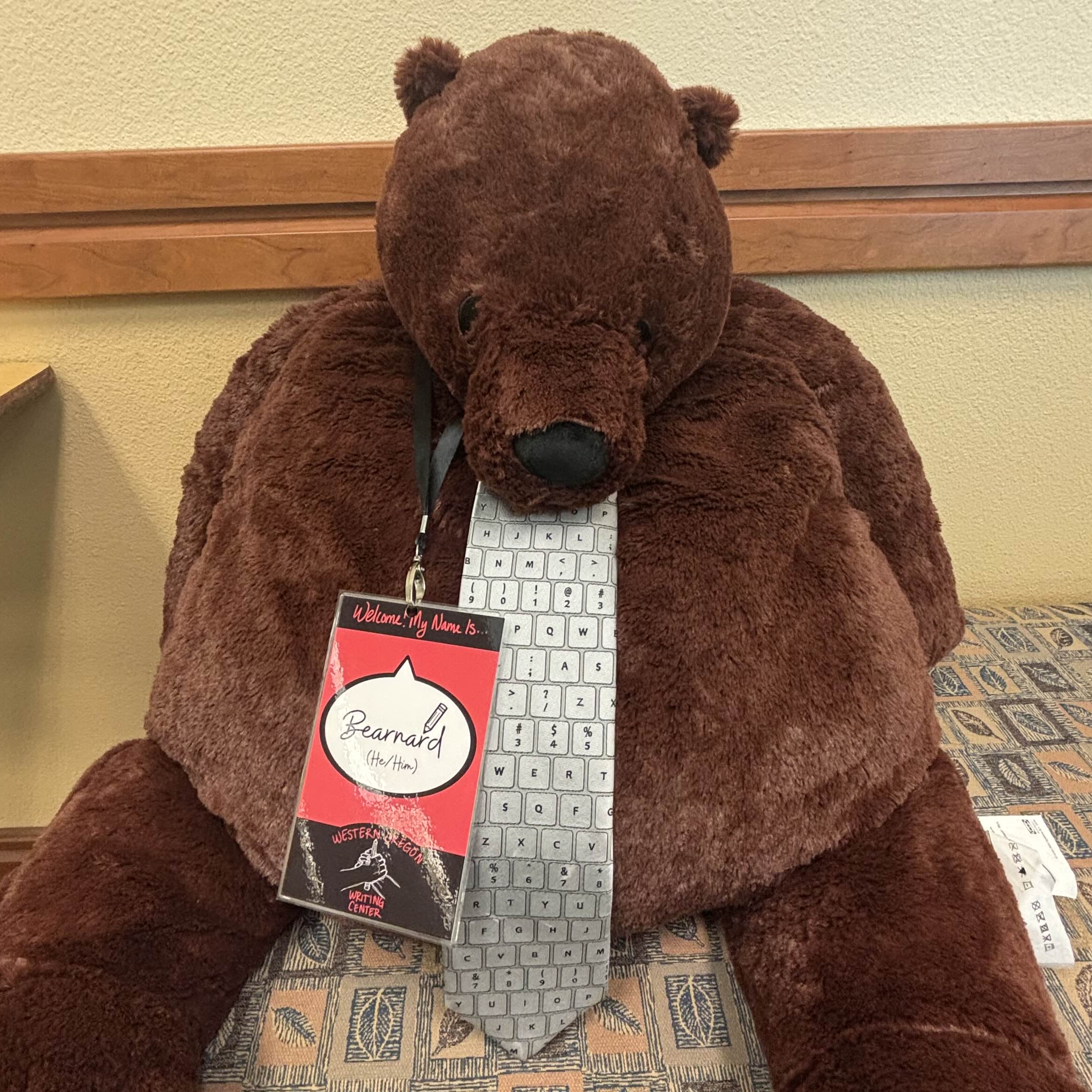 A large stuffed bear with a tie.