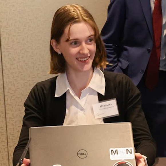 Smiling young person at a meeting.