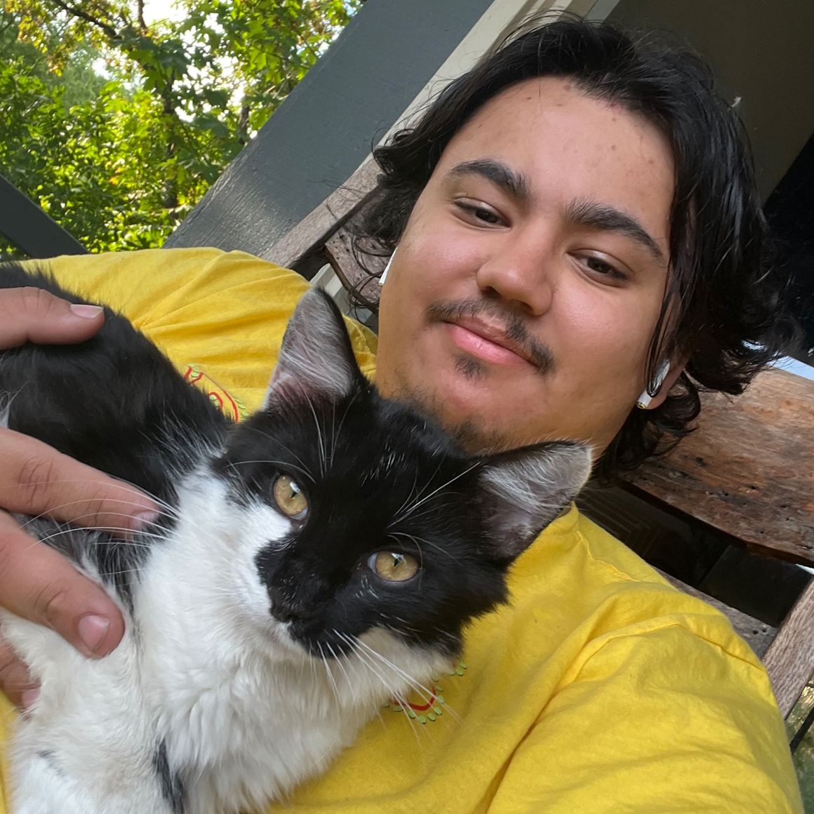Young man with a black and white cat.